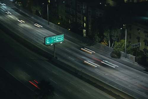 freeway time lapse photo of vehicle on road road