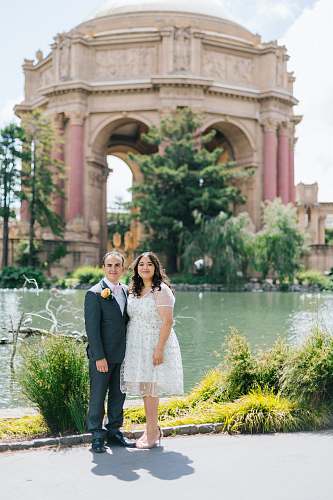 plant woman and man standing beside body of water jar
