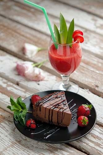 cocktail chocolate cake beside strawberries and wine glass drink