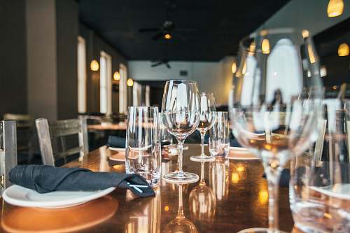 glass clear wine glasses and drinking glasses on brown wooden table restaurant