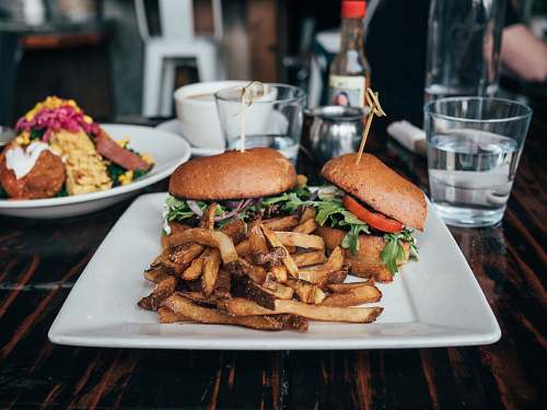 burger selective focus photo of burgers and fries served on plate sandwich