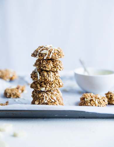 biscuit stack of foods beside white ceramic bowl cookie
