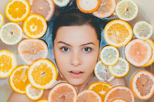 grapefruit woman surrounded by sliced lemons people