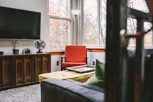 sideboard flat screen TV on white wall inside room bed