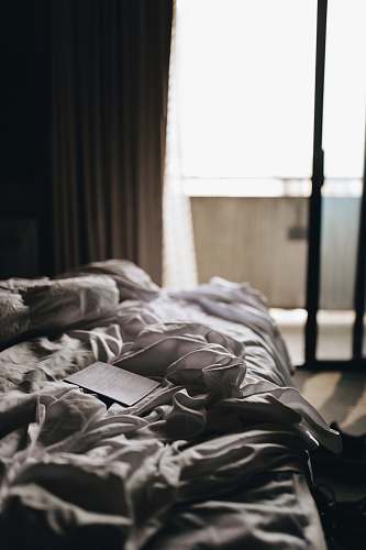 bed white printer paper on white bedspread indoors