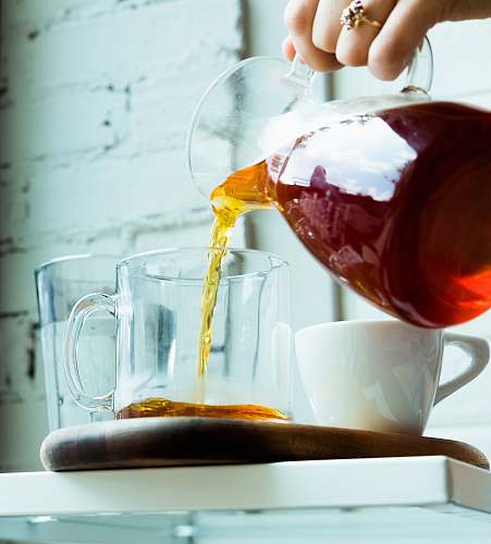 tea person pouring tea on cup cup