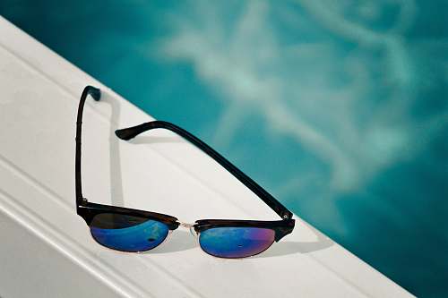 sunglasses clubmaster sunglasses on white surface blue