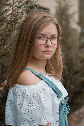 human woman leaning on green plant person