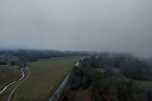 road bird's eye view of road with thick fog during daytime field