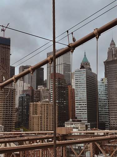 building brown and white concrete buildings under white clouds during daytime banister