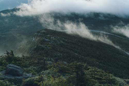 rock green trees under white clouds wilmington