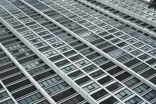 building low-angle photography of white and black high rise building city