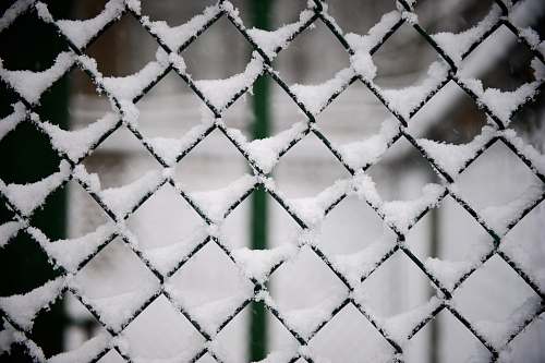 outdoors snow covered black steel fence snow