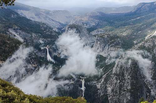 mountain top view of mountain covered with fogs crest