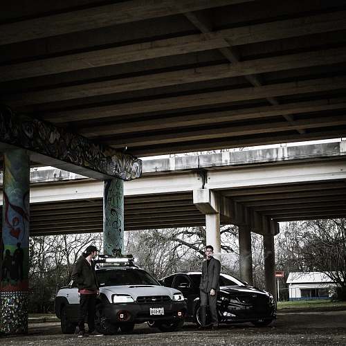 freeway two man standing near cars downtown