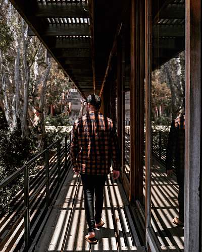 banister man wearing brown and black plaid long-sleeved shirt human