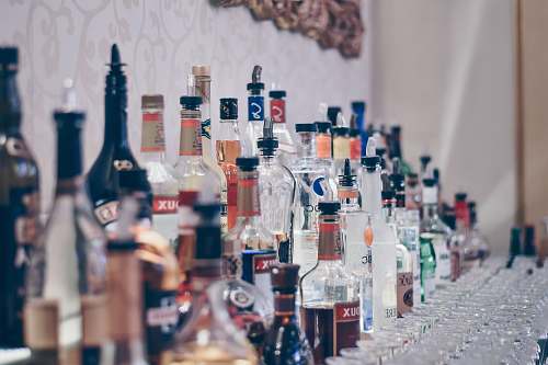 person assorted labeled glass bottle lot people
