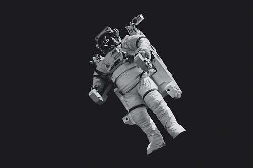 person astronaut in white suit in grayscale photography black-and-white