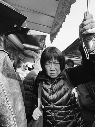 person grayscale photography of a woman holding umbrella black-and-white