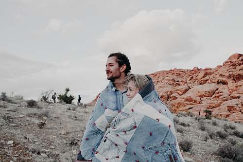person man and woman covered in blue blanket people