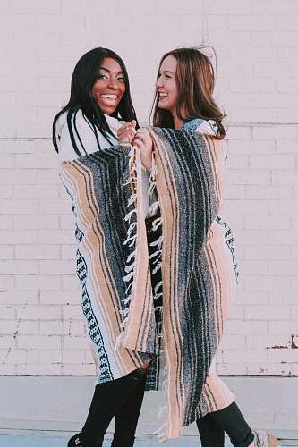 people man and woman standing and covering blanket and smiling person