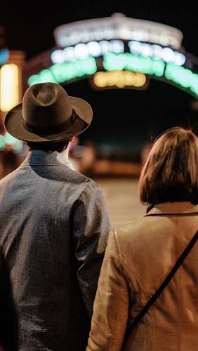 people man and woman standing on street hat