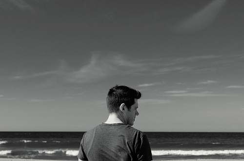 person man near ocean black-and-white