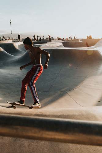 person man playing skateboard during daytime people