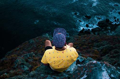 people man sitting in a cliff person