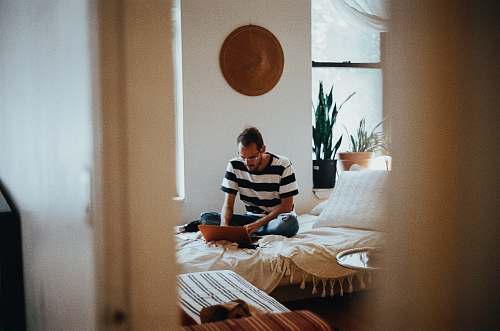 person man sitting on bed people