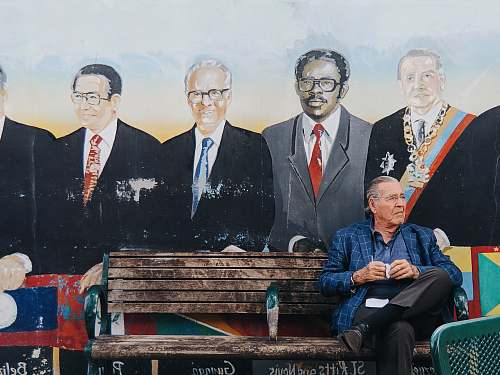 person man sitting on bench sitting