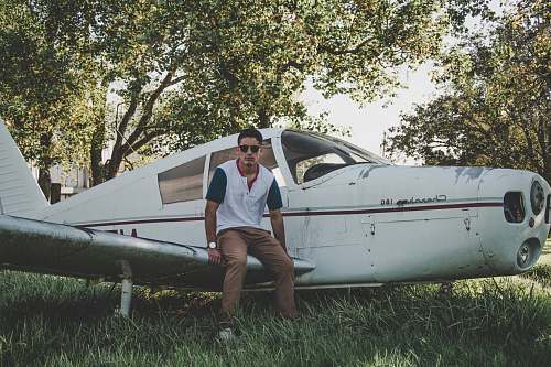 people man sitting on biplane wing person