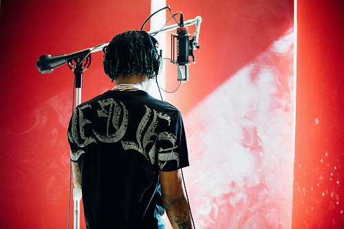person man standing in front of condenser microphone people