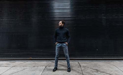 people man standing near black shutter door person