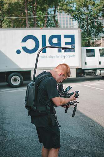 person man taking photo near Epic truck people