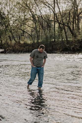 people man walking in the lake at daytime person