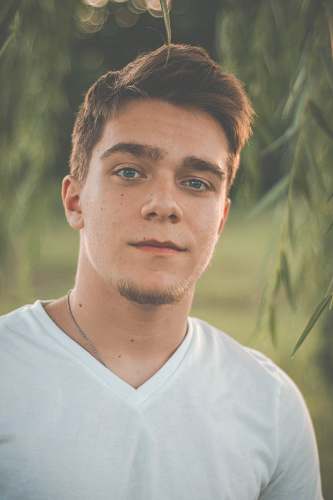 person men's white v-neck shirt close-up photography face