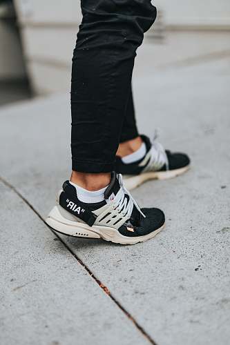 person pair of black and white running shoes people