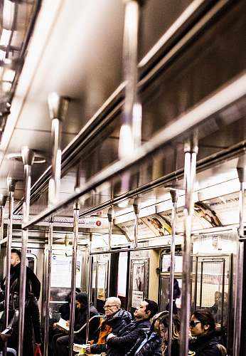 subway people sitting and standing inside train train