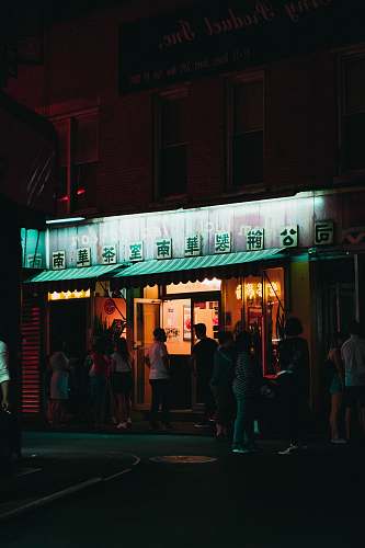 person people standing in front of store during nighttime people
