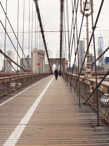 person people walking on bridge during dayime bridge