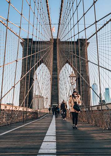 person people walking on bridge during daytime bridge
