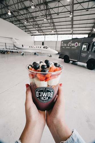 person person holding Bowl'D acai cup people