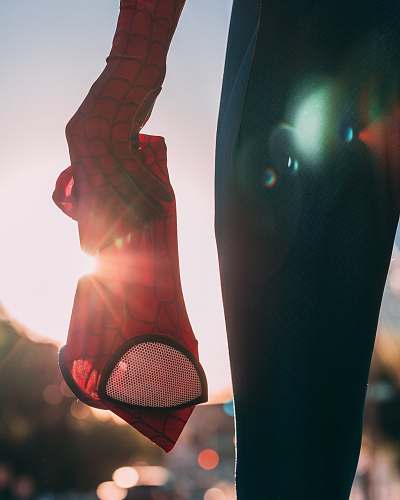person person holding Spider-Man mask people