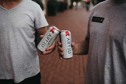 person person holding Ultra cans can