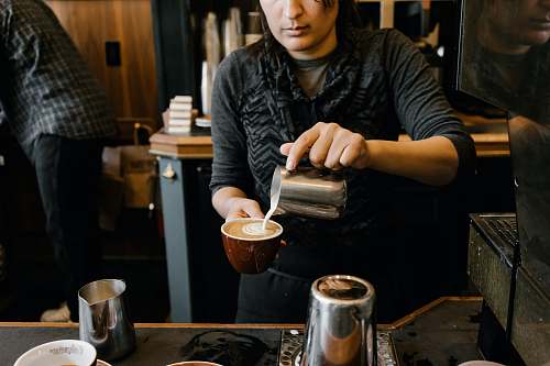 person person making latte cup