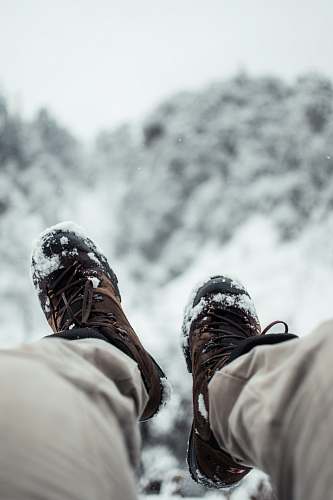 person person wearing brown hiking shoes people
