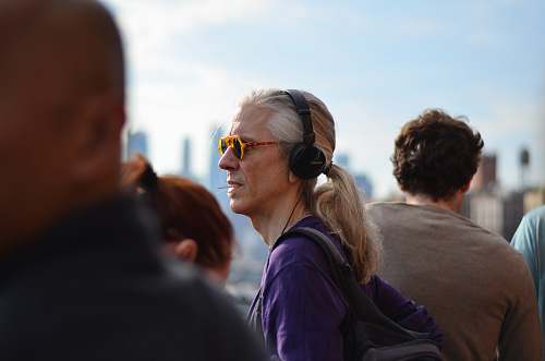 person person wearing purple jacket and headphones accessories