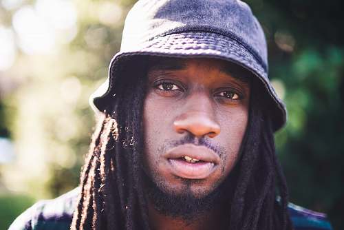 person portrait photography of man with dreadlocks people