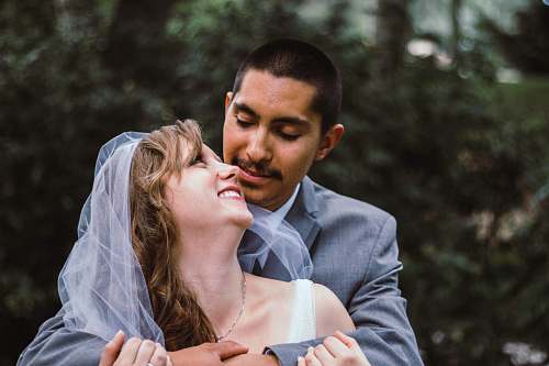 person selective focus photography of man and woman on wedding suits people